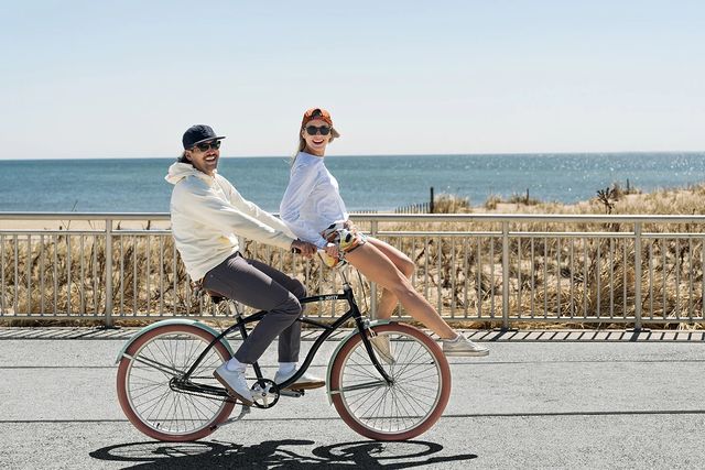 man and woman riding a priority bicycles x jetty coast beach cruiser