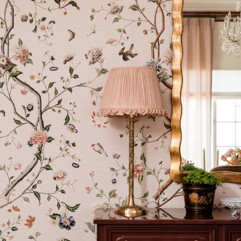 pink floral wallpaper, table lamp with a pink lamp shade