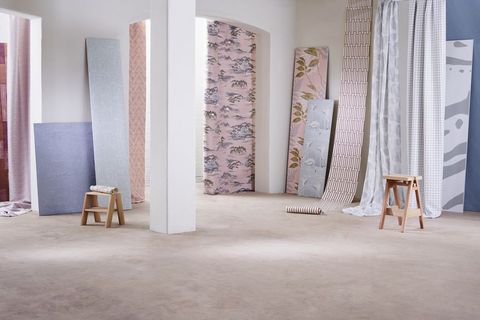 Wallpaper and fabric panels in watery blues and grown-up pinks