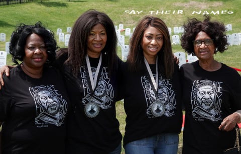 four women in black shirts with george floyd's face