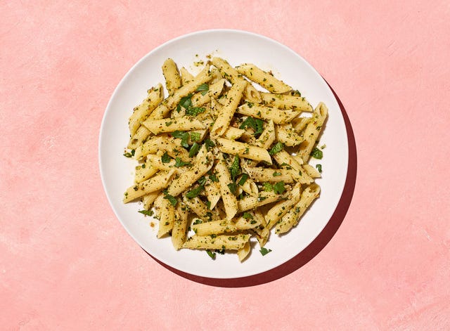 pasta with herbs on a pink background