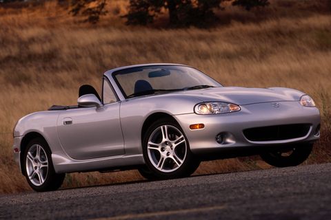 2004 mazda miata parked in front of a field