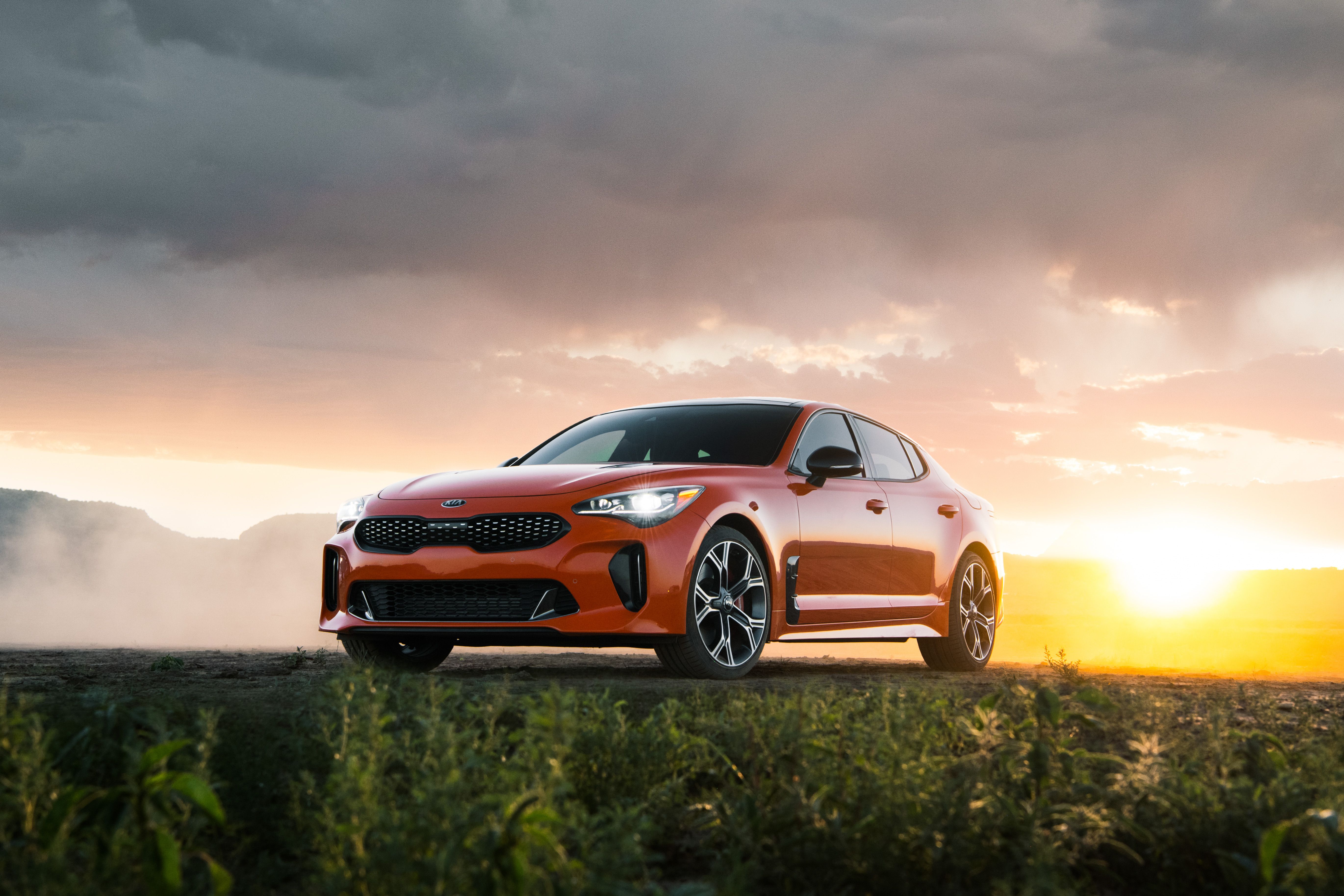 2019 kia stinger gts is a performance bargain with orange paint car and driver