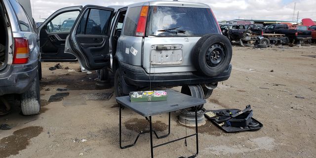 1999 honda cr v with picnic table in junkyard
