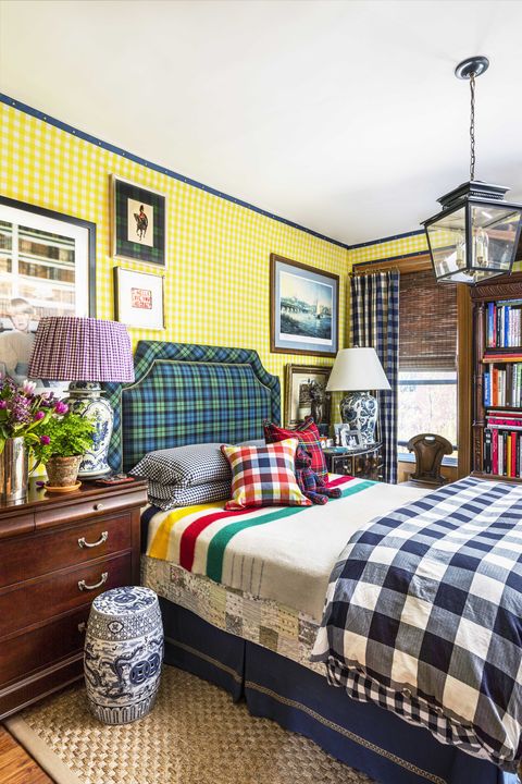 bedroom, tartan bedspread, tartan headboard, tartan wallcovering, bedside stool, vintage chest of drawers in brown
