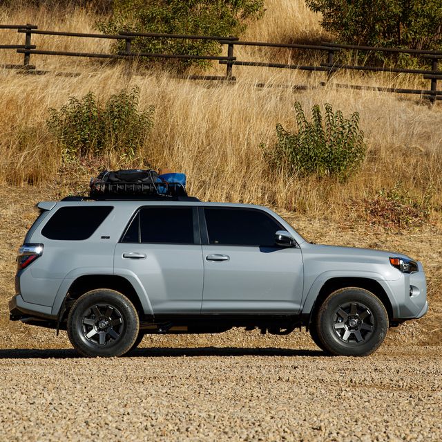 toyota 4runner parked next to a mountain ranch fence