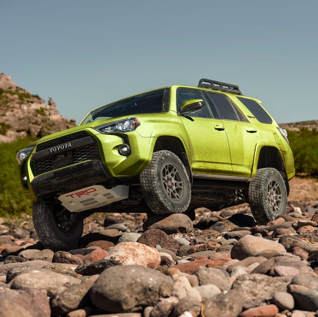toyota 4runner trd pro with left front wheel perched on a rock