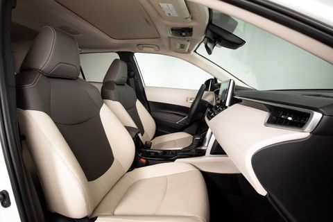 interior of toyota corolla cross viewed form passenger side with a blank studio background