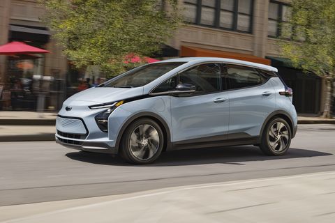 2023 bolt ev side profile while driving on an urban city street