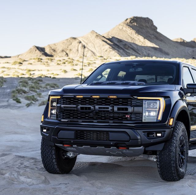 ford f 150 raptor r parked in the sand