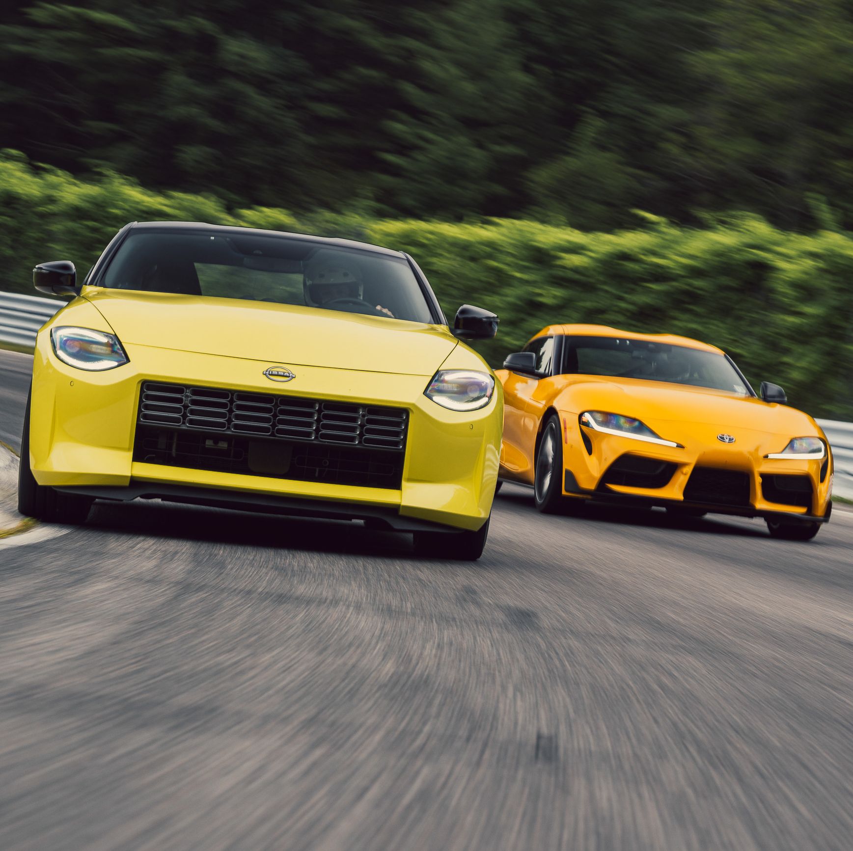 Yellow Nissan and a dark yellow Toyota racing side by side