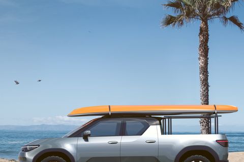 toyota electric pickup with surfboard on the roof
