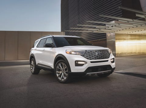ford explorer hybrid in front of a modern parking garage