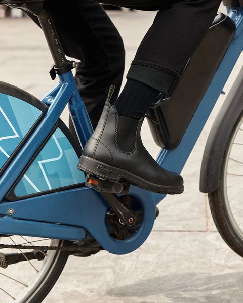 person riding a bike wearing vegan blundstone boots