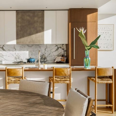 A List 2022 - ELLE DECOR sunny white kitchen detail with rush stools