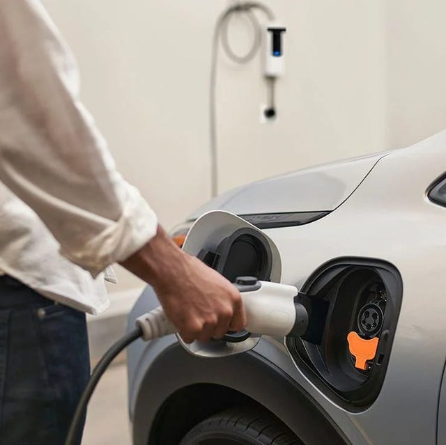 man charging a chevrolet bolt ev car