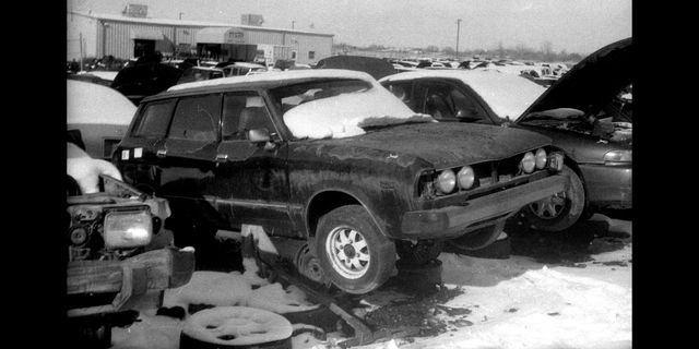 1978 subaru leone wagon in colorado junkyard photographed with hanimex praktica nova 1b film camera