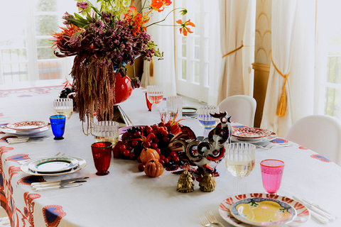 a table in a home with plates and centerpieces to illustrate news that mytheresa launches home and life section 2022