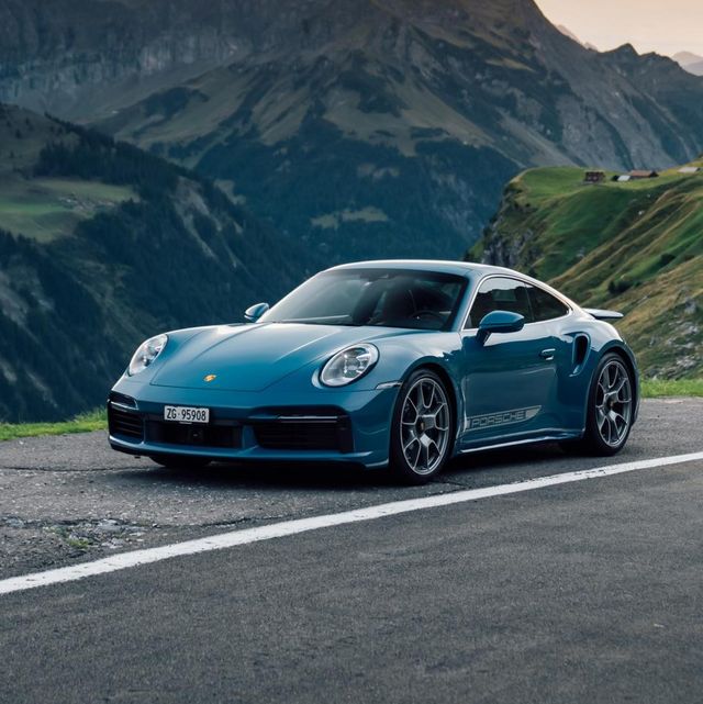 porsche 911 turbo parked beside a curvy mountain road
