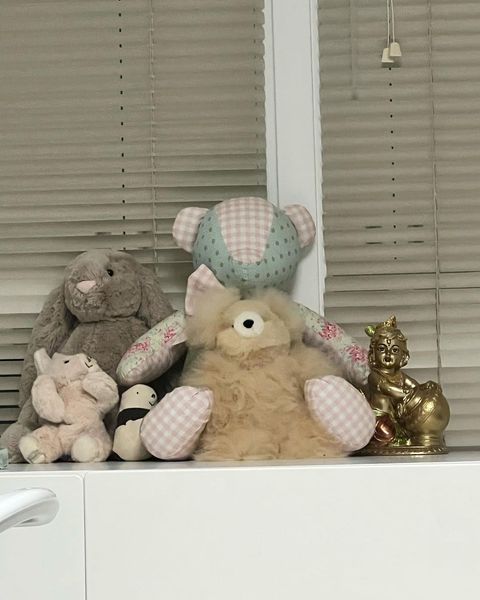 stuffed animals on a white shelf