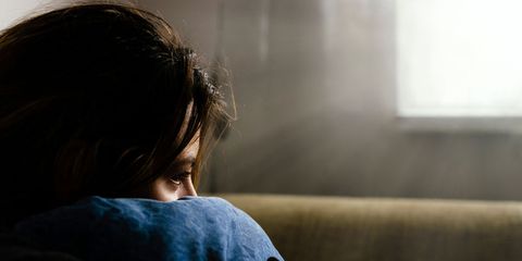 depressed woman sitting in dark