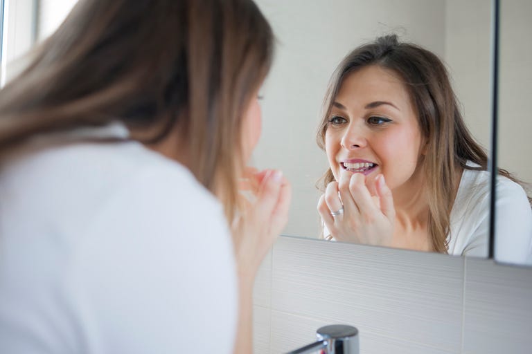 woman looking in mirror