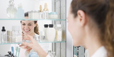 woman looking at medicine cabinet