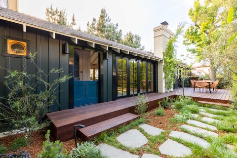 front yard, stone stepping stones, wooden deck with table and chairs