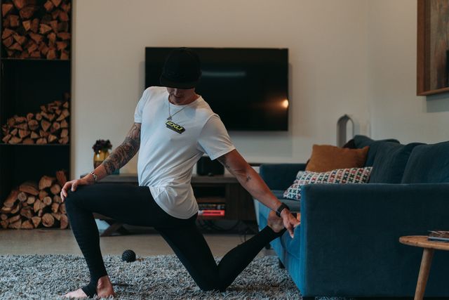man stretching while wearing 2xu legging