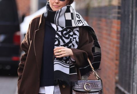 london, england   february 18 guest in long brown coat, sunglasses, snakeskin handbag attends bora aksu at st james the less church during london fashion week february 2022 on february 18, 2022 in london, england photo by neil mockfordgetty images