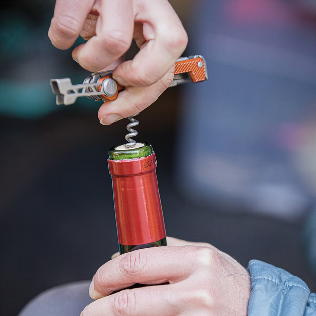 a person holding a small red and white object