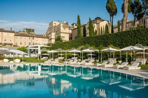 hotel pool with white umbrellas