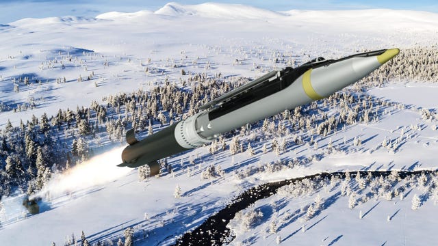 ground launched small diameter bomb in black and yellow flying over wintry forest