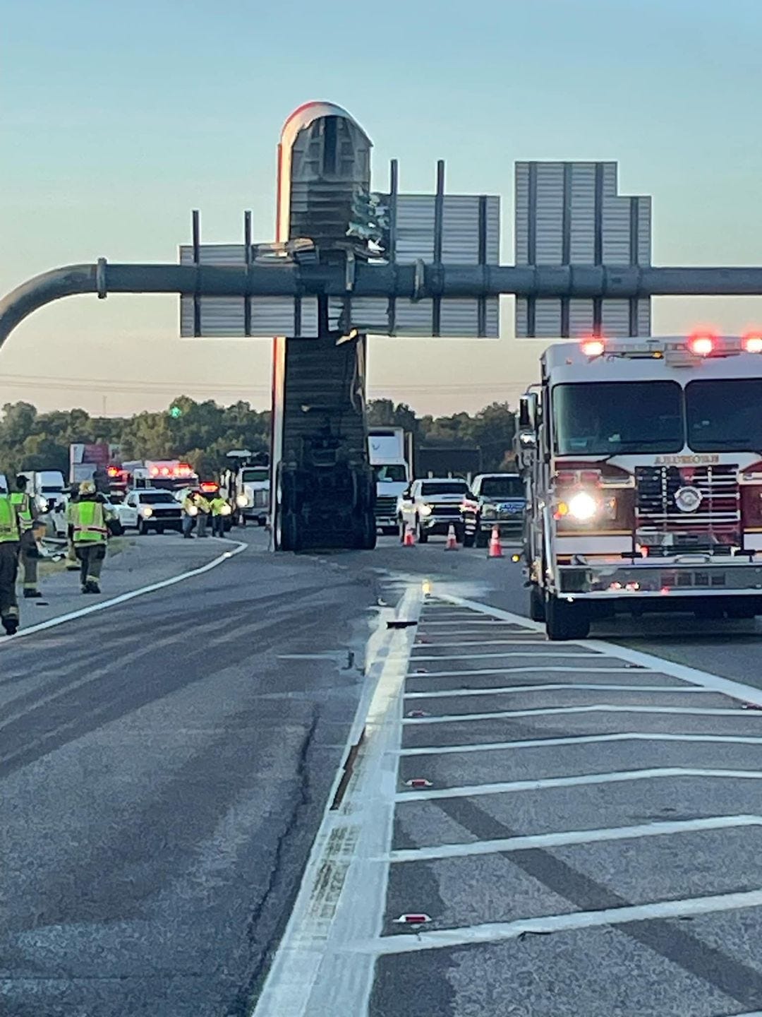 This Is a Trailer Stuck Upright On a Highway Sign