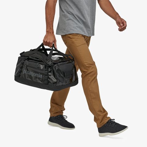 a person carrying a patagonia duffel