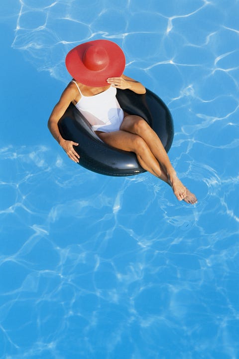 Girl sitting in a pool float in swimming pool girl sitting in a pool float in swimming pool