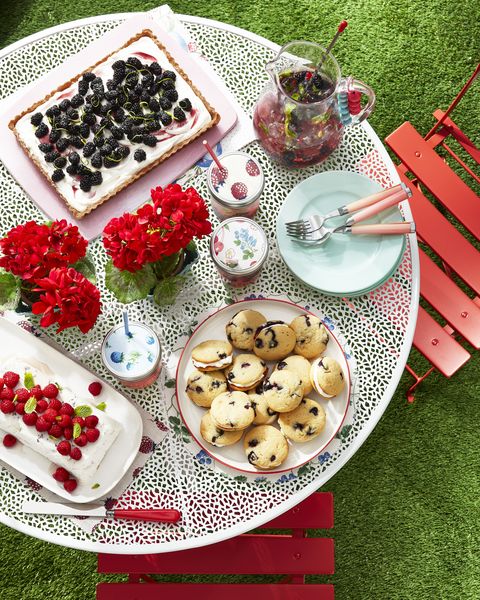 table filled with delicious treats made from fresh berries including whoopie pies, a tart, and refreshing drink