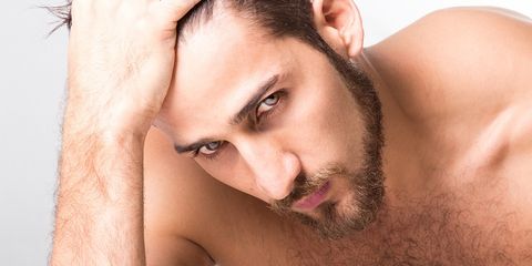 Close-Up Of Shirtless Handsome Man Against White Background