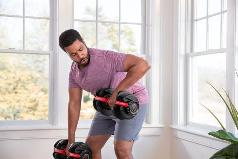 man lifting with bowflex dumbbells