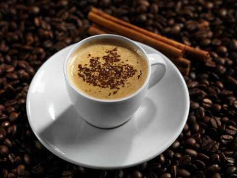 Cup of coffe latte with chocolate on coffee beans background