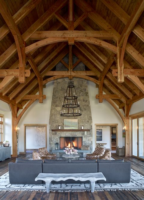 a rustic living room with a stone fireplace