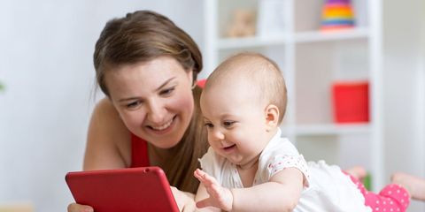 A mom and baby looking at an ipad