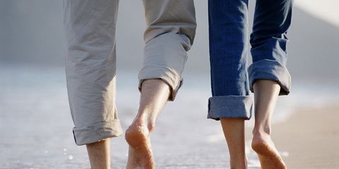 Couple contracts hookworm walking on beach