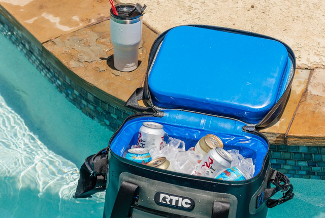 rtic soft pack cooler filled with ice and beer and floating in pool