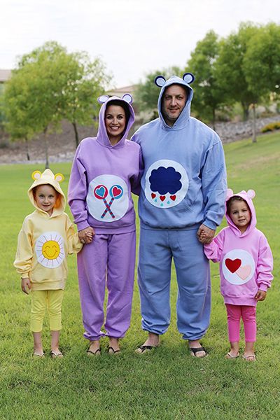 a family dressed as four different, colorful care bears as part of an '80s group halloween costume