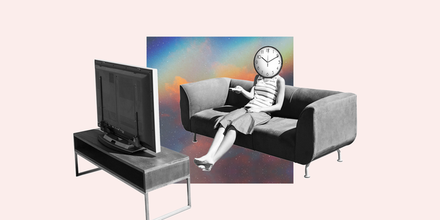 a woman sitting on a couch watching a tv