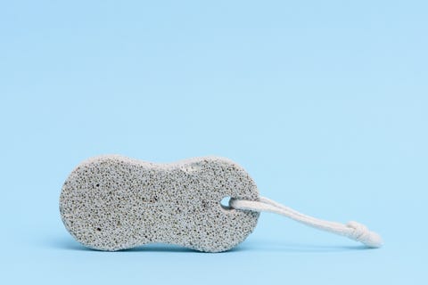 foot care tool a pumice stone to scrub, and remove the callus from the foot, on a light blue background