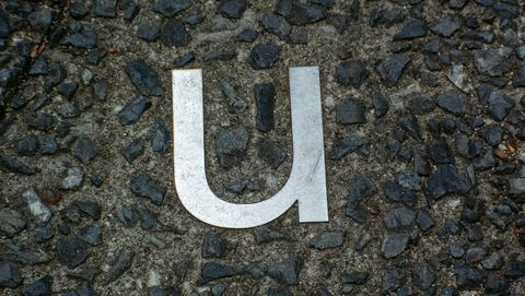 a small letter of the metal alphabet embedded in a road