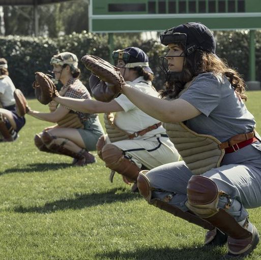 a league of their own season 1, characters squatting in baseball gear with arms outstretched
