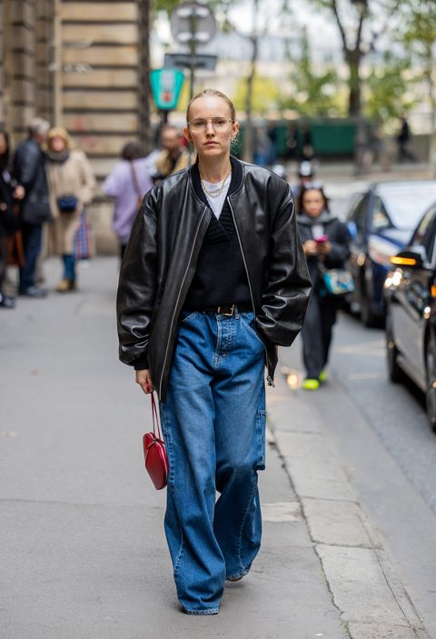 paris, france   september 28 alexandra carl wears denim jeans, red heart shaped bag, bomber leather jacket outside cecilie bahnsen during paris fashion week   womenswear springsummer 2023  day three on september 28, 2022 in paris, france photo by christian vieriggetty images